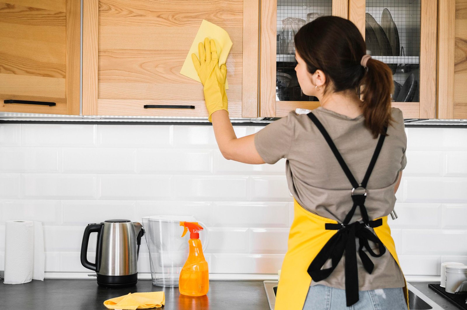 medium shot woman cleaning kitchen